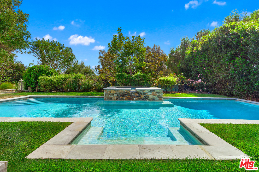 6763 Zumirez Drive Malibu, CA 90265 - Photo 44 of 52 a view of a garden with lawn chairs