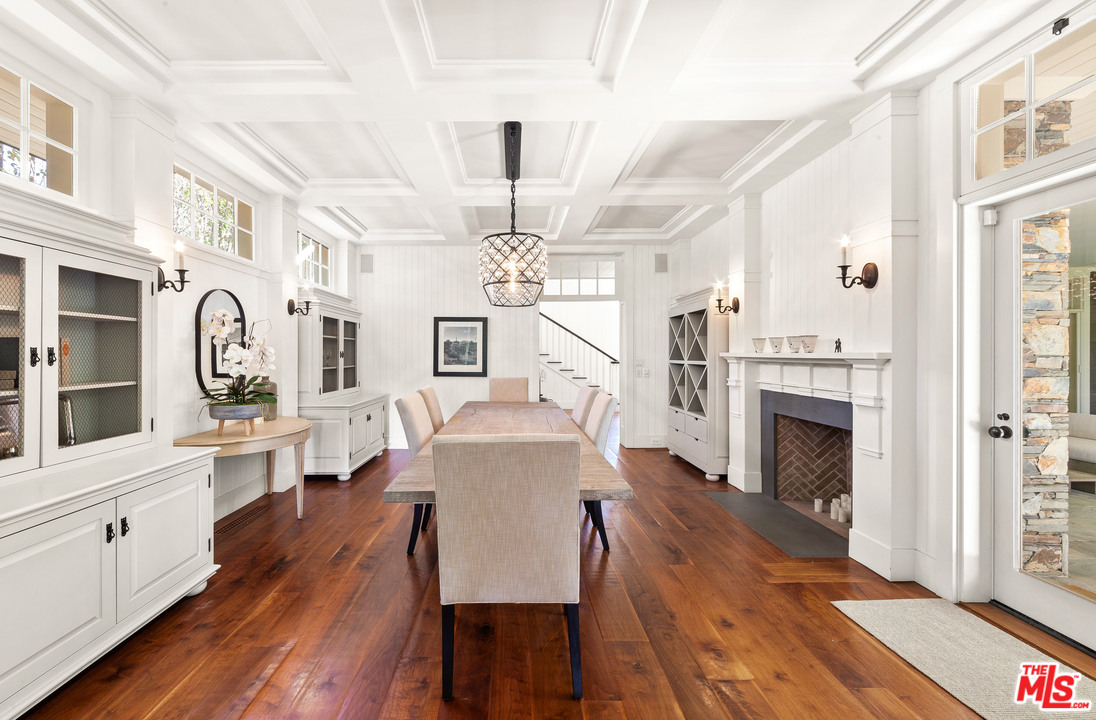 6763 Zumirez Drive Malibu, CA 90265 - Photo 6 of 52 a living room with furniture a fireplace and wooden floor