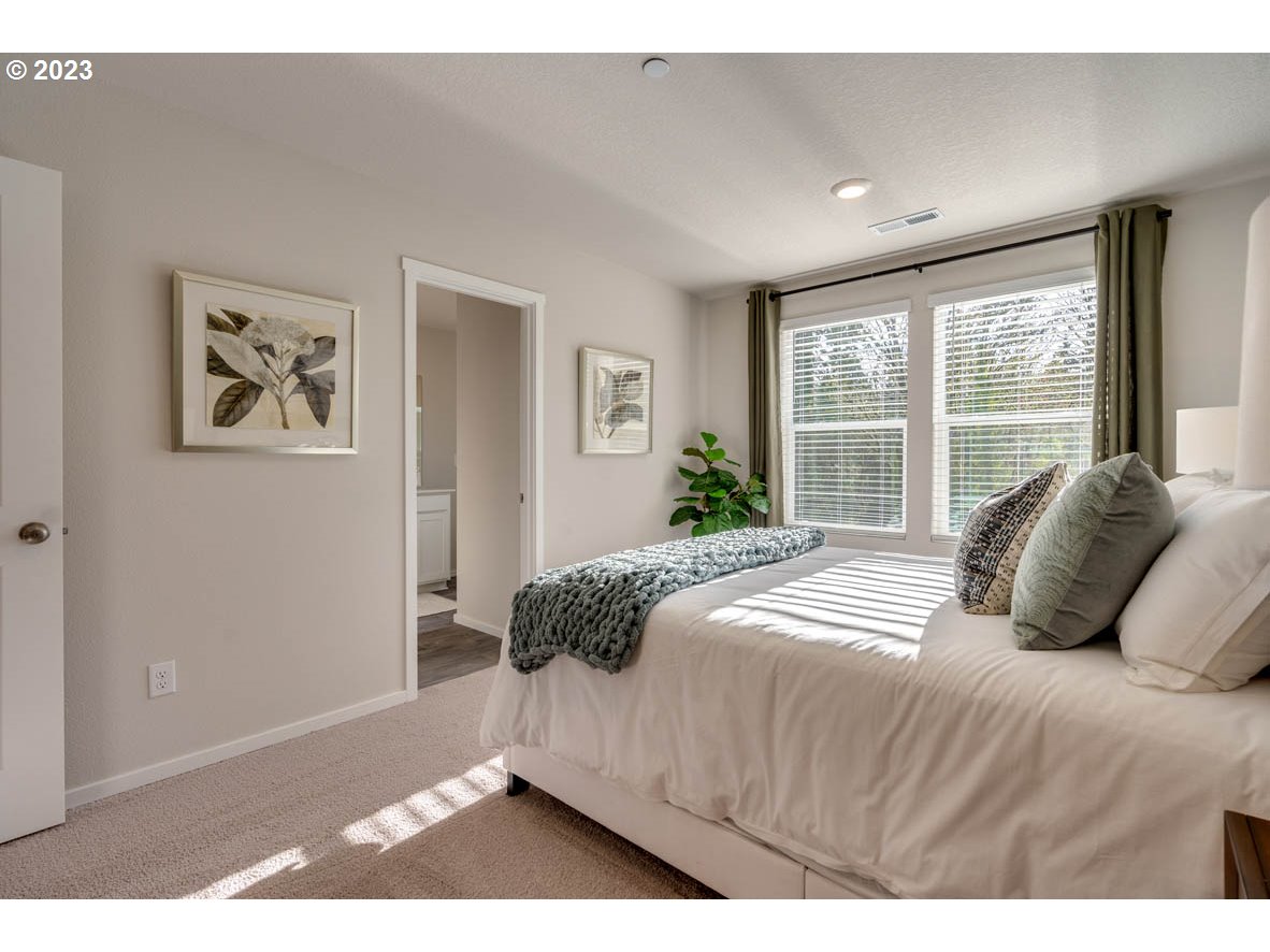 2733 North 2nd Way Ridgefield, WA 98642 - Photo 17 of 24 a bedroom with a large bed and a window