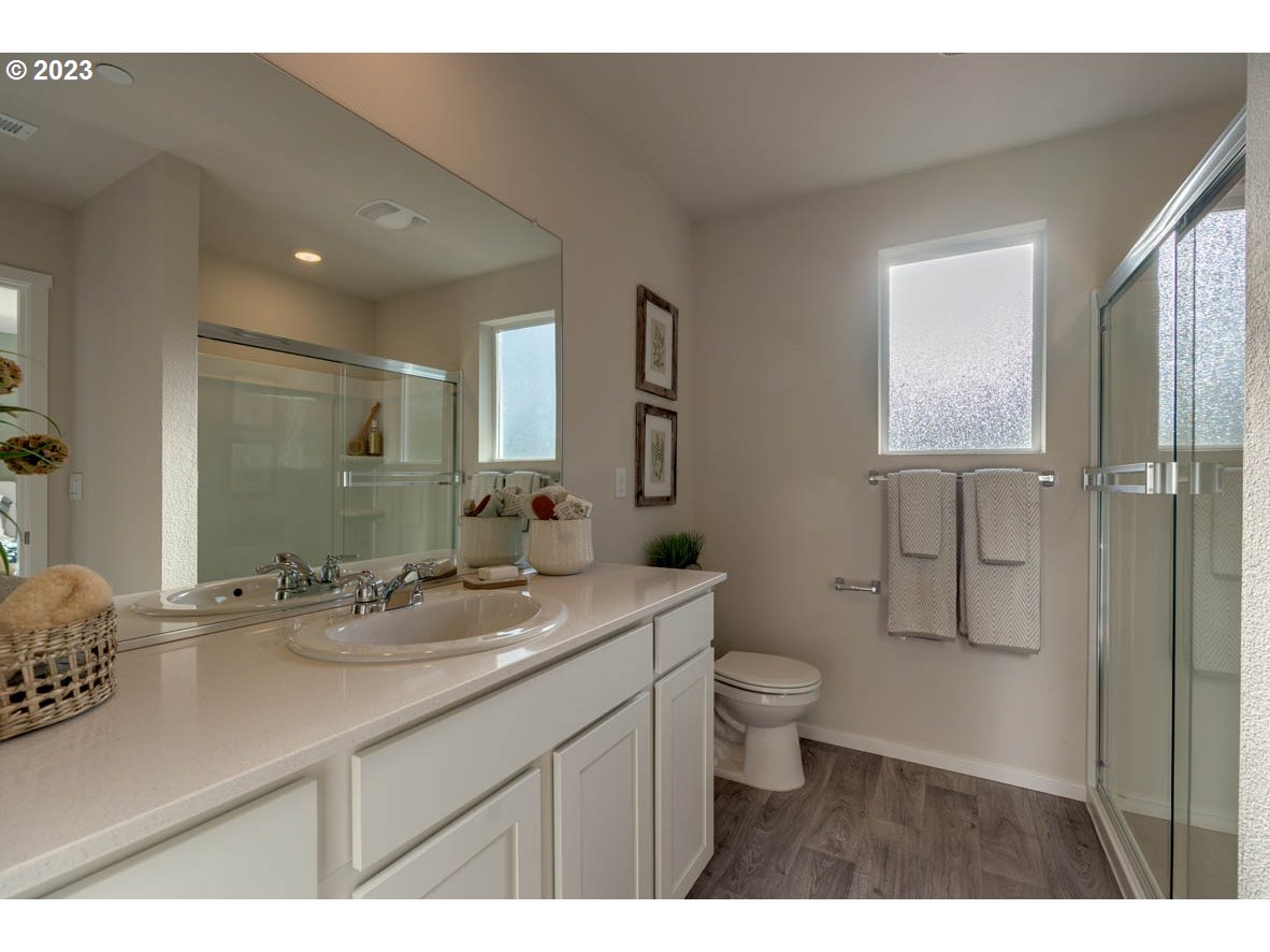 2733 North 2nd Way Ridgefield, WA 98642 - Photo 18 of 24 a bathroom with a granite countertop sink a toilet and a mirror