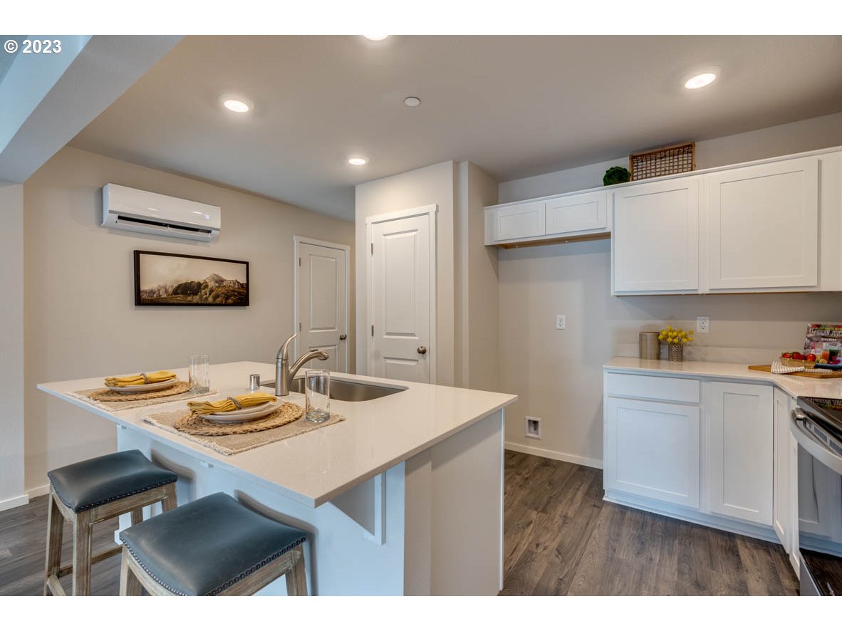 2733 North 2nd Way Ridgefield, WA 98642 - Photo 5 of 24 a kitchen with a sink cabinets and wooden floor