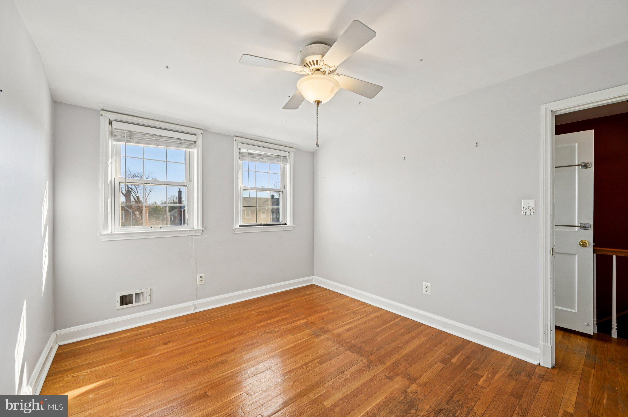 8334 Wyton Road Baltimore, MD 21286 - Photo 18 of 44 a view of an empty room with wooden floor and a window