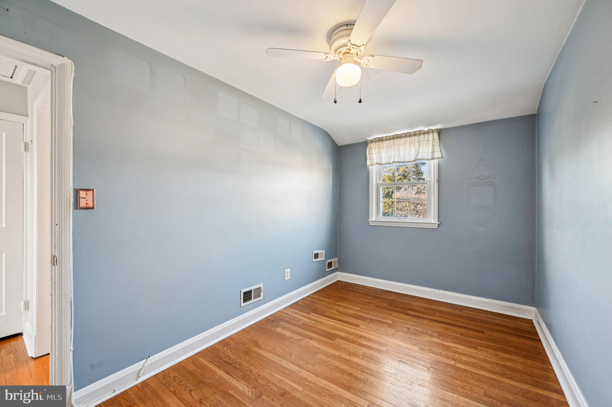 8334 Wyton Road Baltimore, MD 21286 - Photo 22 of 44 wooden floor in an empty room with a window