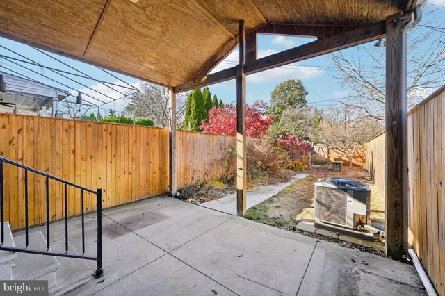 a view of a house with a tree in front of it
