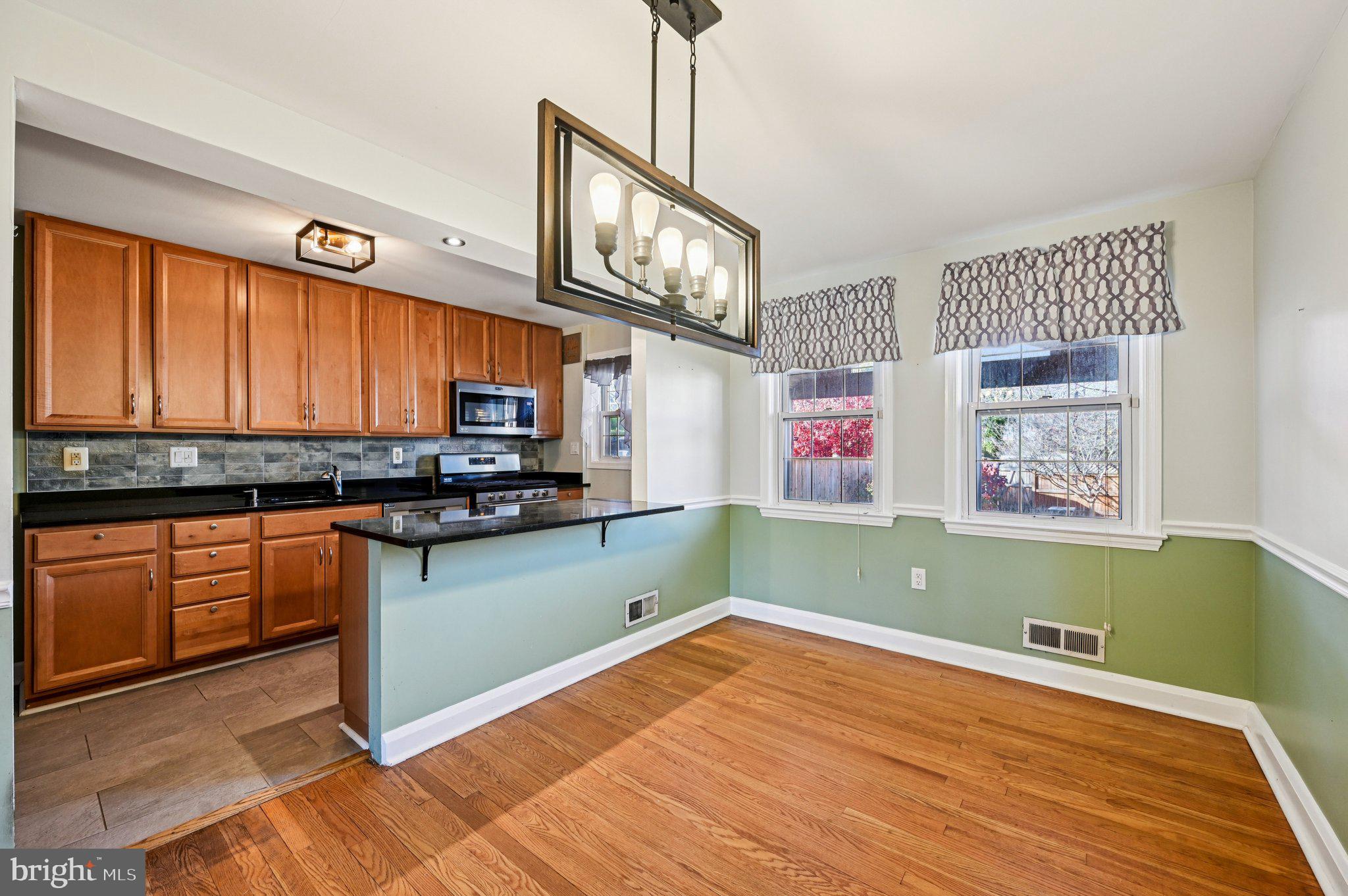 8334 Wyton Road Baltimore, MD 21286 - Photo 10 of 44 a kitchen with stainless steel appliances wooden cabinets a stove top oven a sink and dishwasher