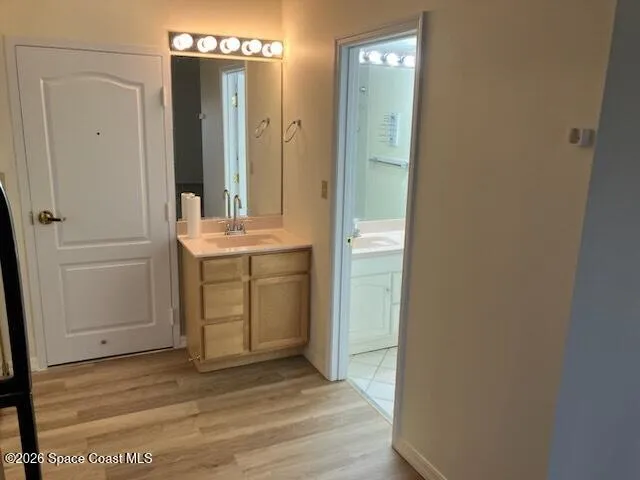 a view of a bathroom with mirror and sink