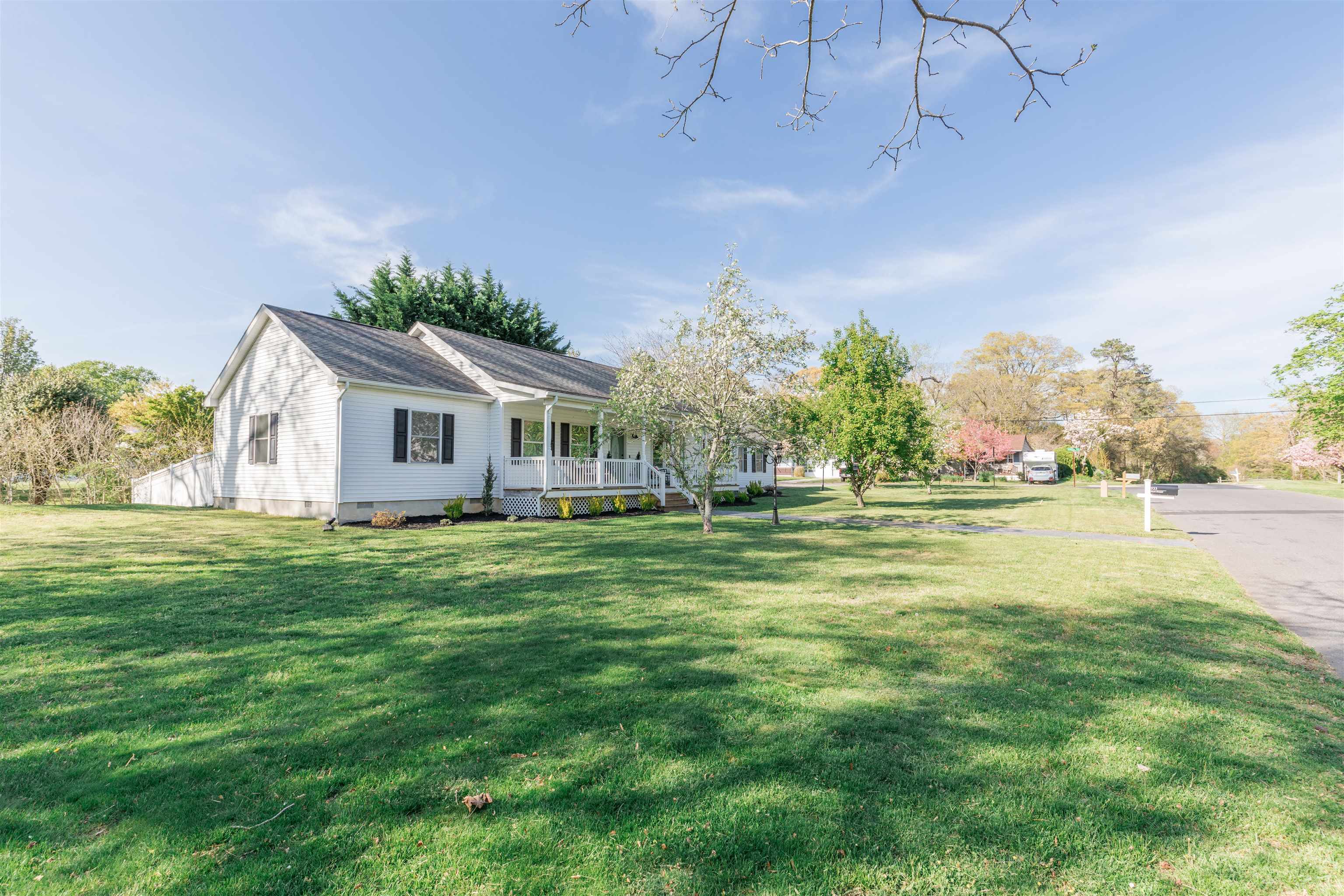 933 Main Street Erma, NJ 08204 - Photo 24 of 24 a front view of house with yard and trees in the background