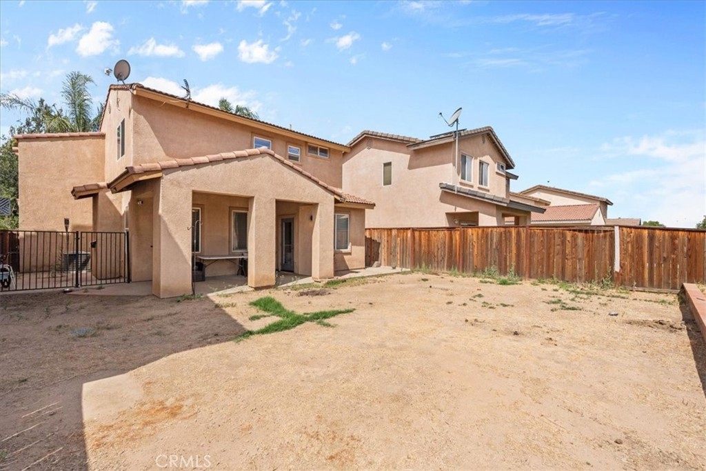 1474 Albillo Loop Perris, CA 92571 - Photo 29 of 35 a view of a house with wooden fence