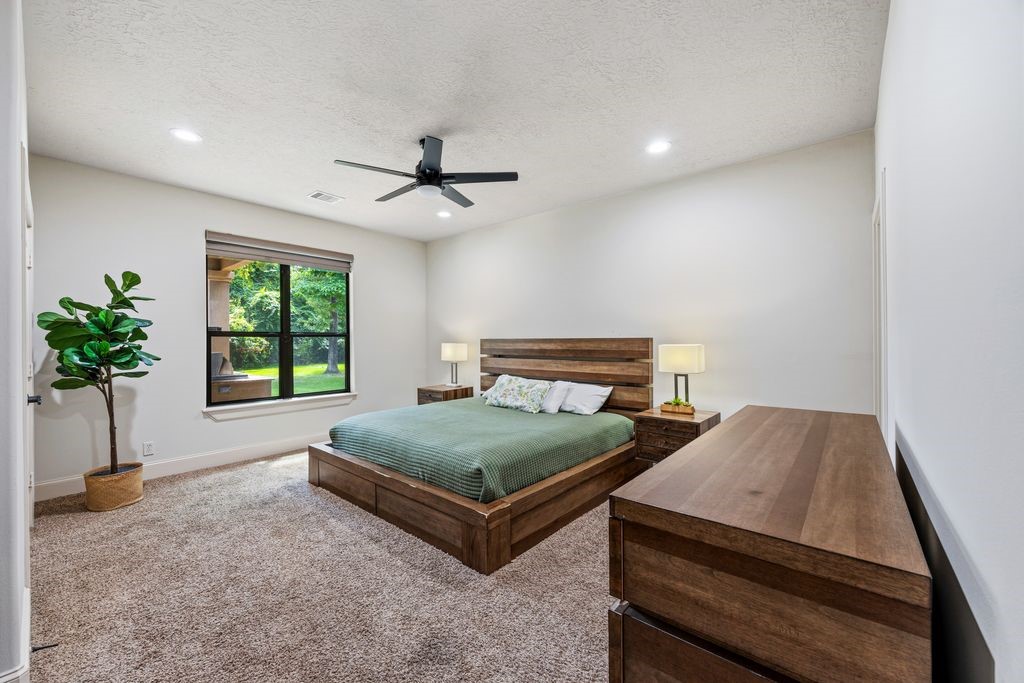 27722 Tiverton Court Spring, TX 77386 - Photo 17 of 33 Ideal Guest or In-Law Suite: Privately situated on the first floor, this spacious secondary bedroom offers independence and comfort with its own expansive en-suite bathroom and generous closet space, making it an exceptional accommodation for extended family or overnight guests.