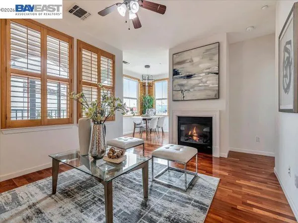 a kitchen with granite countertop white cabinets and stainless steel appliances