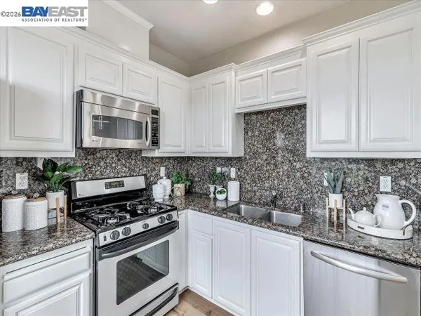 a kitchen with stainless steel appliances a stove a microwave and a refrigerator