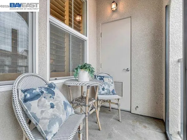 a bedroom with a bed a flat screen tv and a potted plant