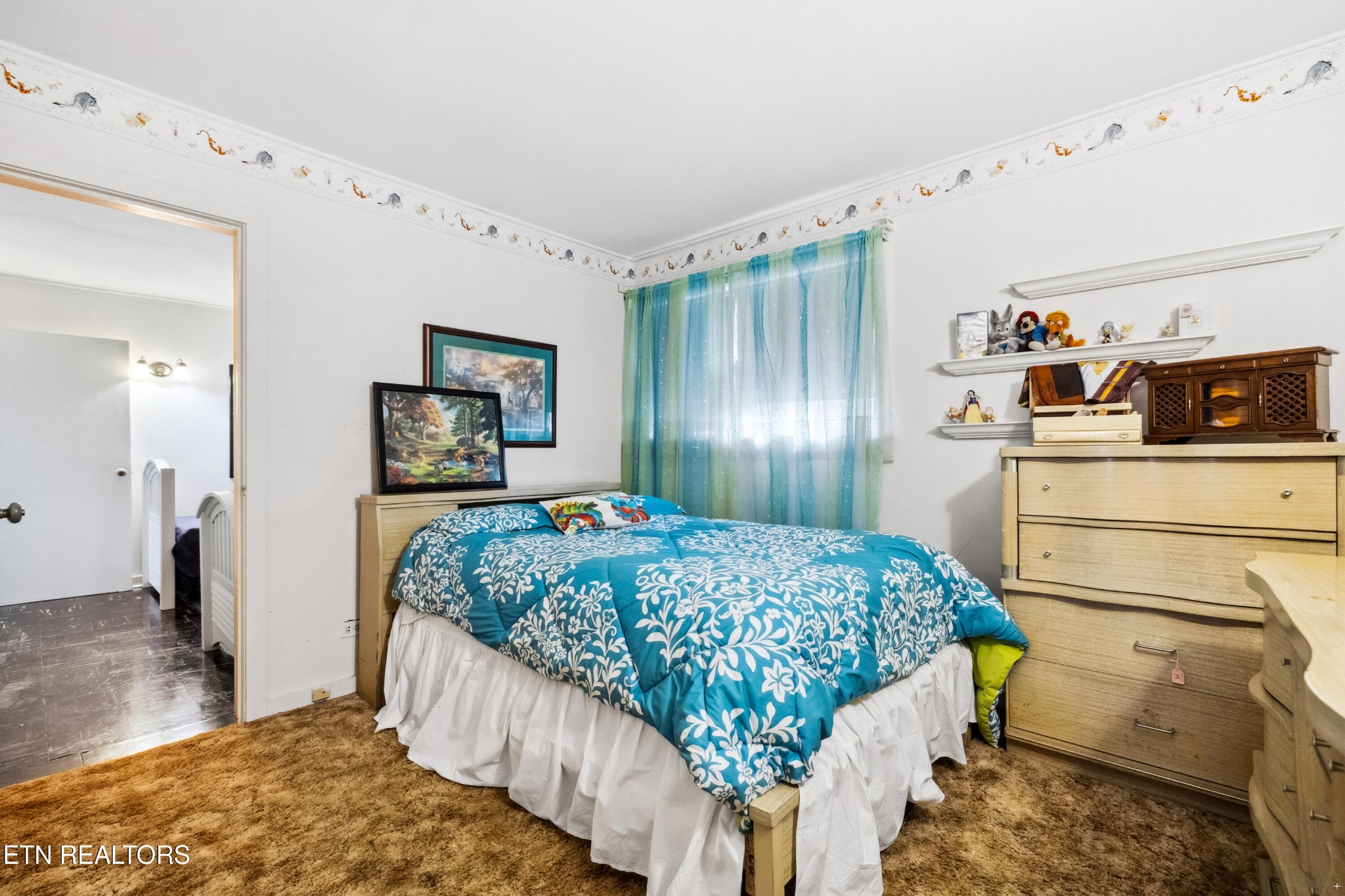 125 Marquette Road Oak Ridge, TN 37830 - Photo 12 of 21 a bedroom with a bed and a flat tv screen on the dresser