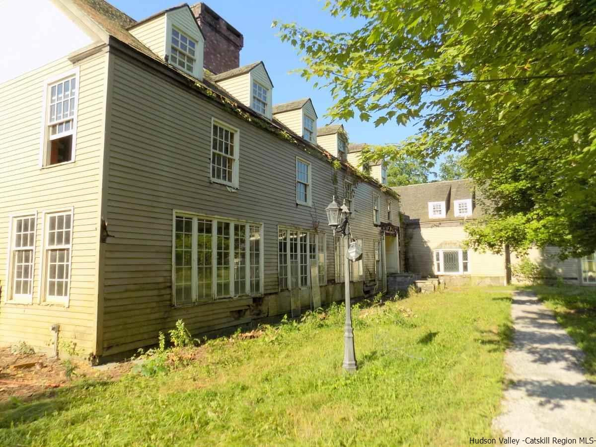 a view of a house with a yard covered in snow