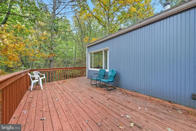 a living room with fireplace furniture and a large window