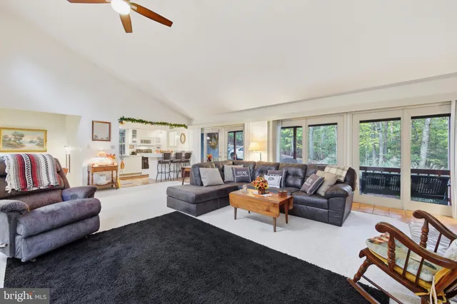 a living room with furniture ceiling and flat screen tv