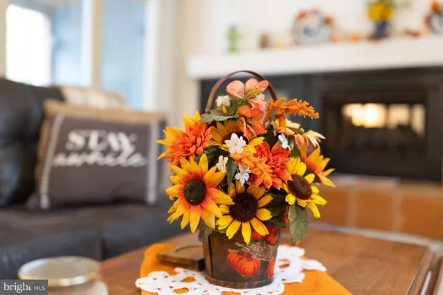 a living room with furniture a flat screen tv and a large window