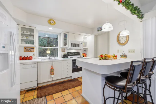 a kitchen with a white cabinets and stove