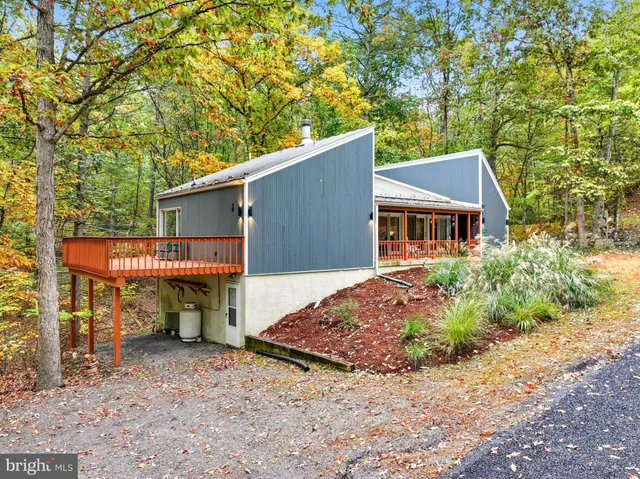 a view of a house with a patio and backyard