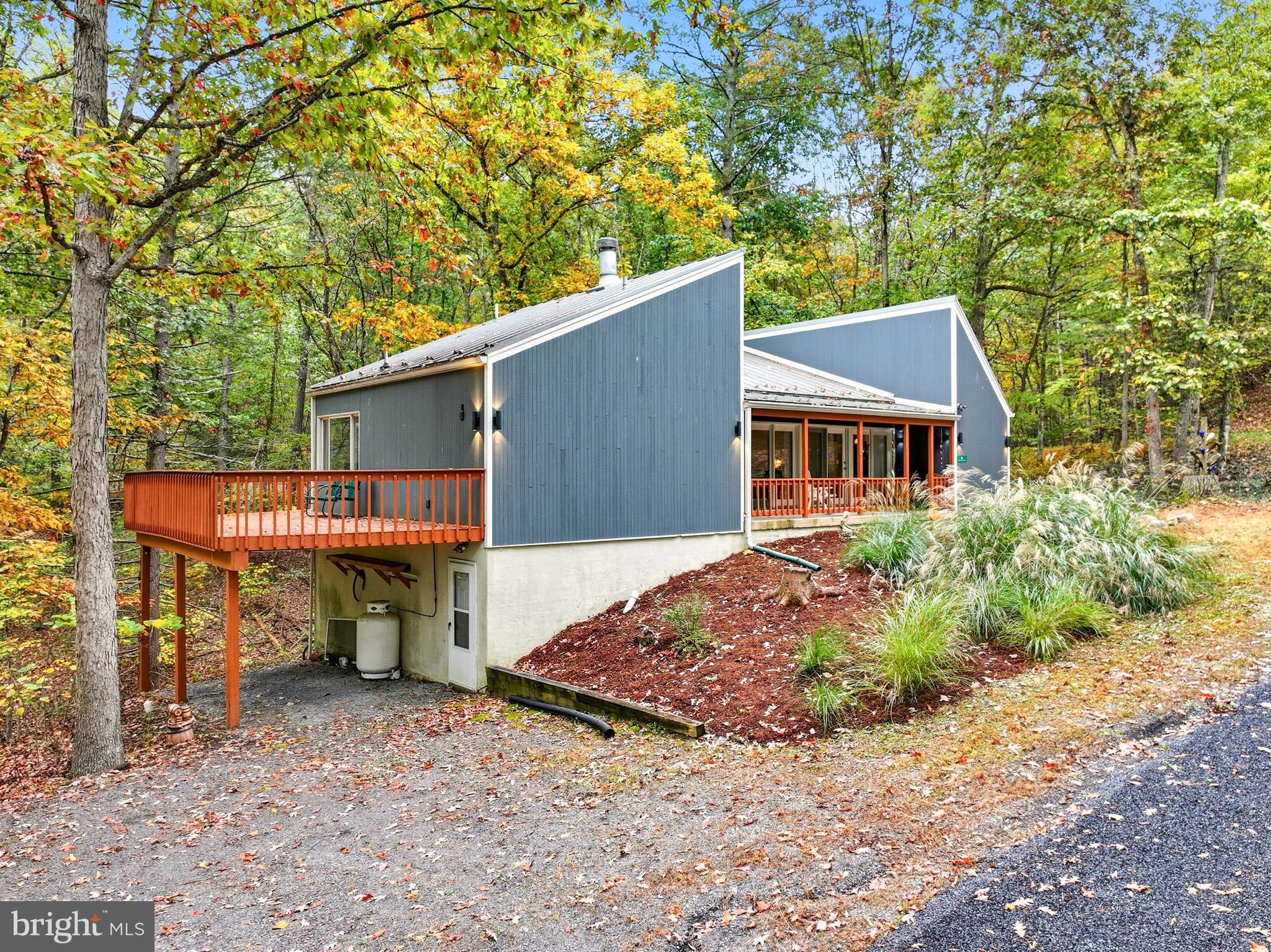 16 Spruce Hollow Road Basye, VA 22842 - Photo 3 of 50 a view of a house with a patio and backyard