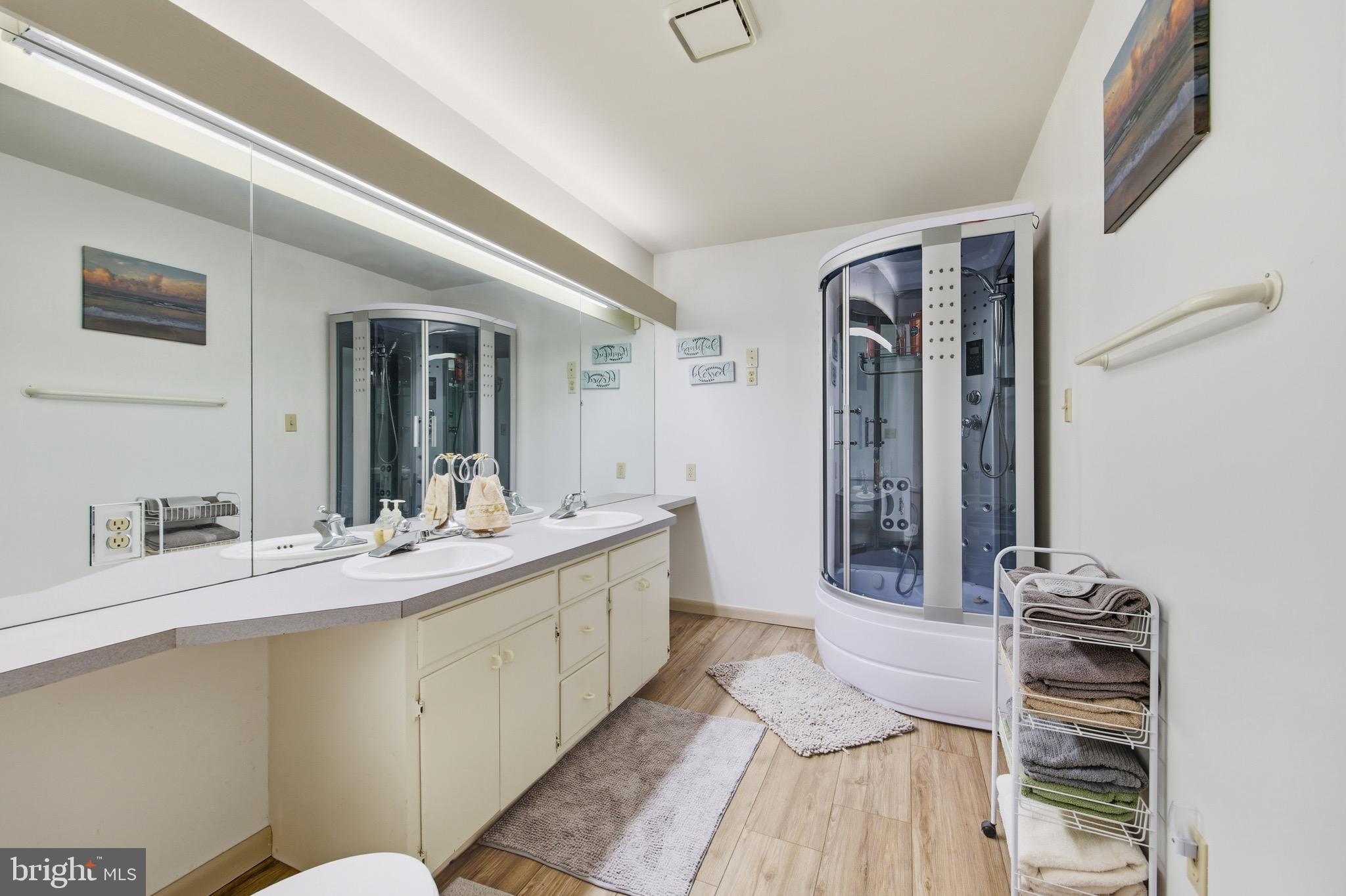 16 Spruce Hollow Road Basye, VA 22842 - Photo 32 of 50 a en suite bathroom with a double vanity sink and a mirror