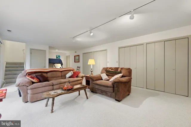 a living room with furniture a large window and a rug