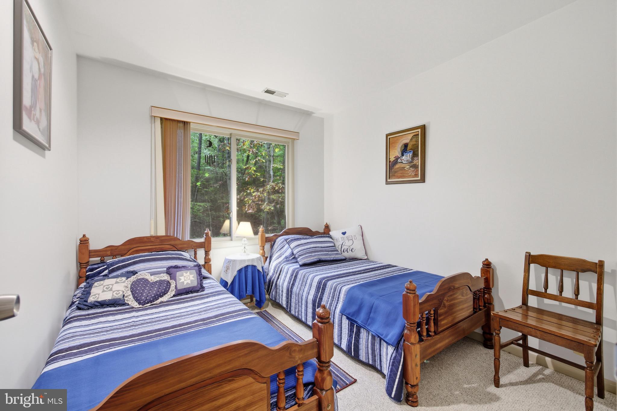 16 Spruce Hollow Road Basye, VA 22842 - Photo 37 of 50 a bedroom with two beds and a large window