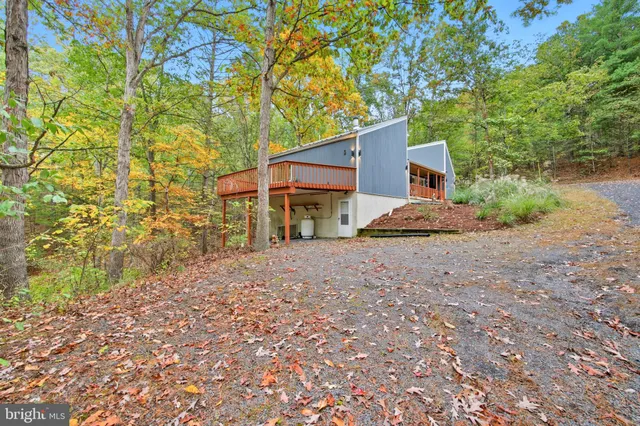 a view of a house with a tree in the yard