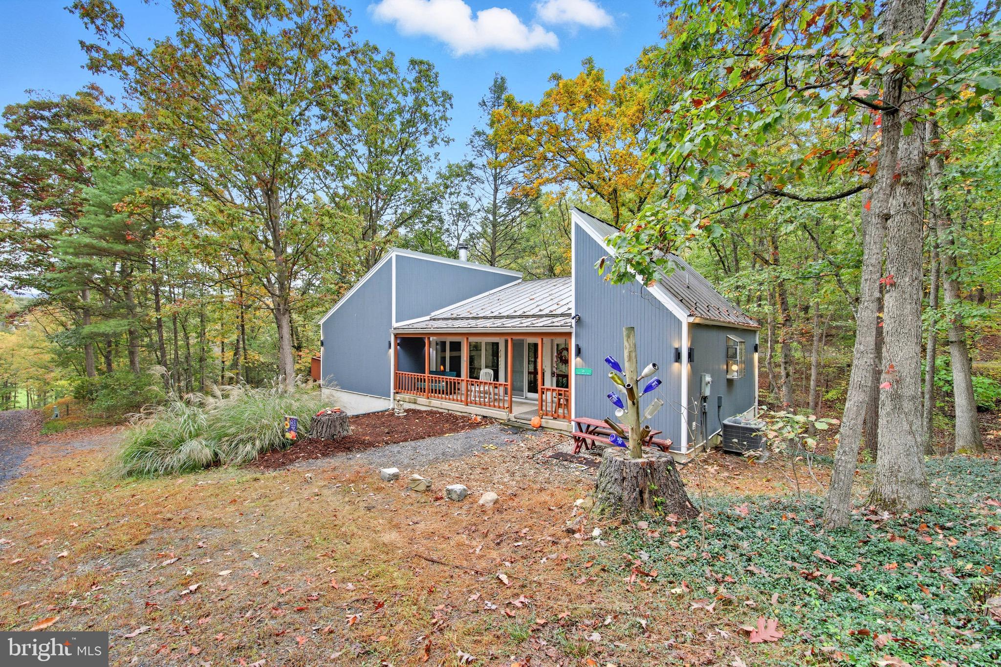 16 Spruce Hollow Road Basye, VA 22842 - Photo 8 of 50 a view of a house with a tree in the yard