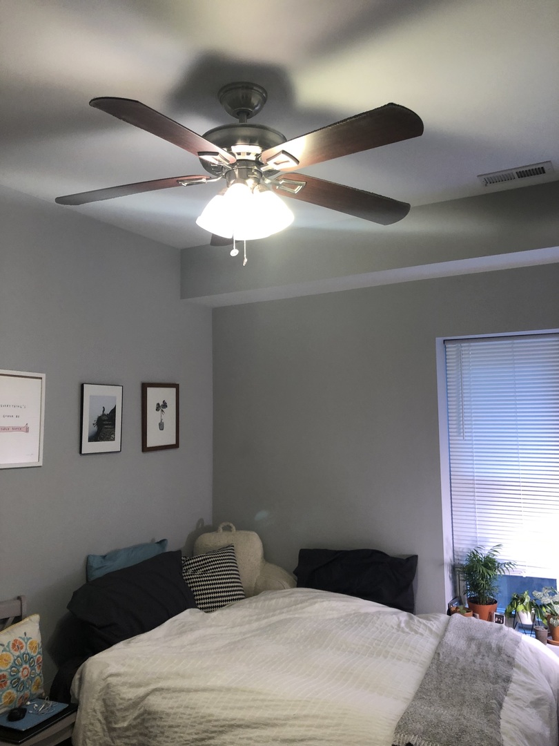 926 West George Street, Unit 3R Chicago, IL 60657 - Photo 7 of 21 a bedroom with a bed and a chandelier