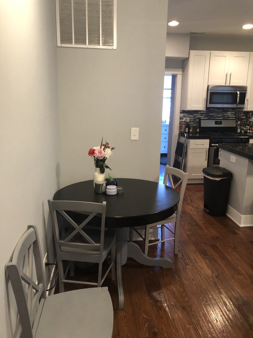 926 West George Street, Unit 3R Chicago, IL 60657 - Photo 8 of 21 a view of a dining room with furniture and wooden floor