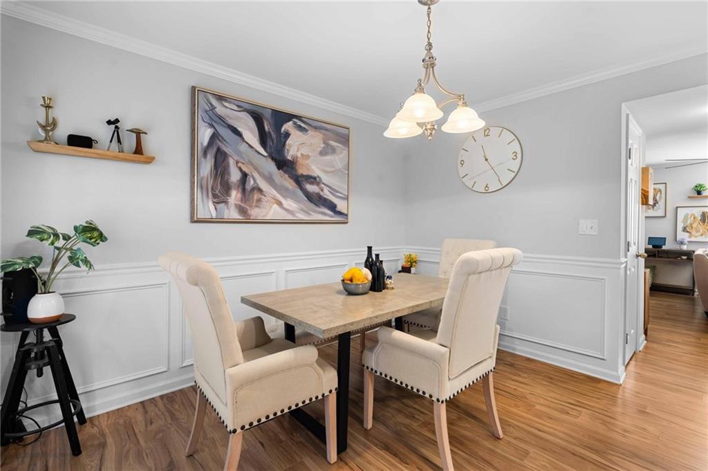 6900 Roswell Road, Unit N5 Atlanta, GA 30328 - Photo 12 of 47 a view of a dining room with furniture wooden floor and a chandelier