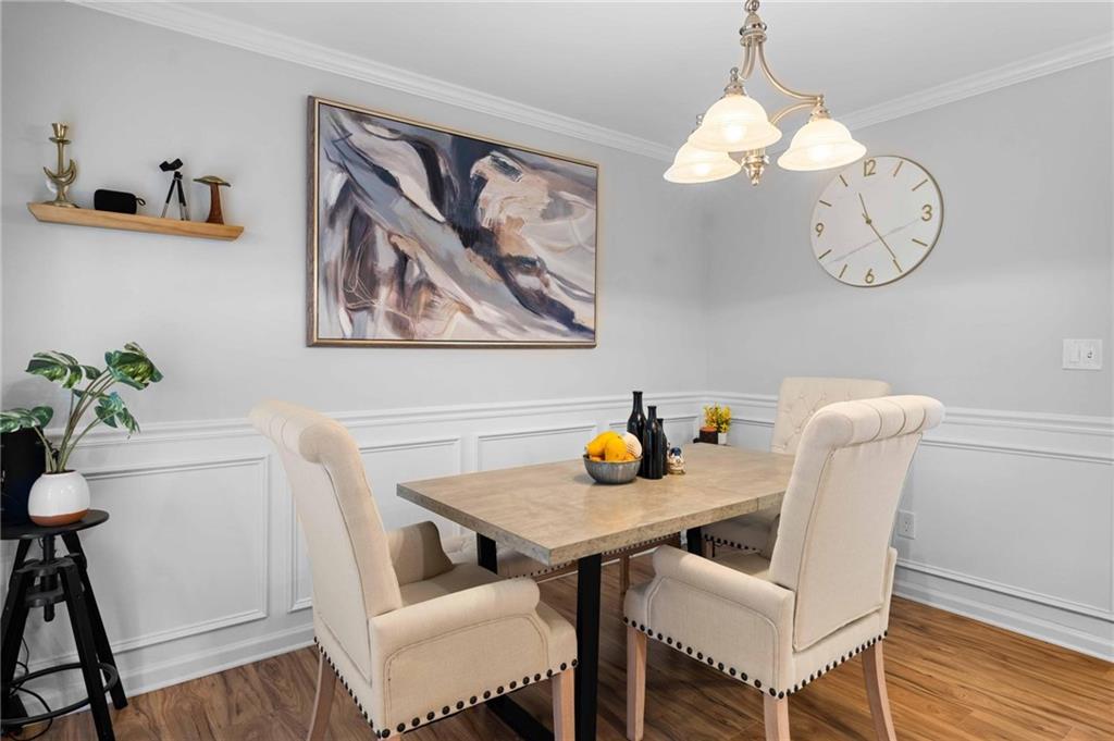 6900 Roswell Road, Unit N5 Atlanta, GA 30328 - Photo 13 of 47 a view of a dining room with furniture and wooden floor