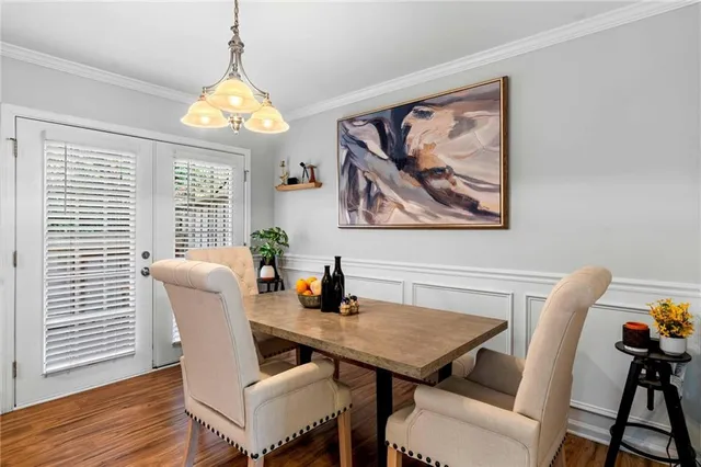 a view of a dining room with furniture and a chandelier
