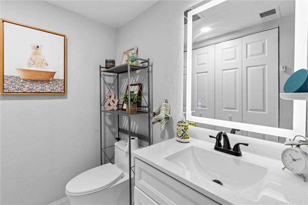 6900 Roswell Road, Unit N5 Atlanta, GA 30328 - Photo 18 of 47 a bathroom with a sink a toilet and mirror