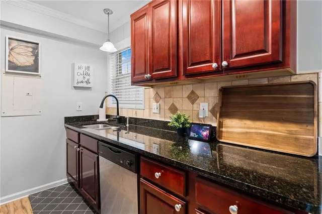 a kitchen with stainless steel appliances granite countertop a sink stove and cabinets