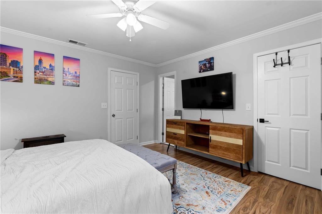 6900 Roswell Road, Unit N5 Atlanta, GA 30328 - Photo 26 of 47 a bedroom with furniture and a flat screen tv