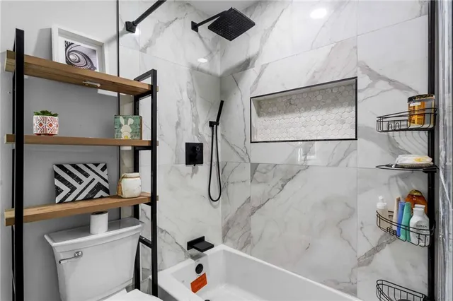 a bathroom with a tub and shower