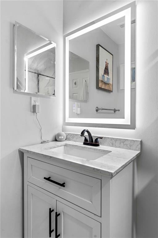 6900 Roswell Road, Unit N5 Atlanta, GA 30328 - Photo 29 of 47 a bathroom with a sink and a mirror