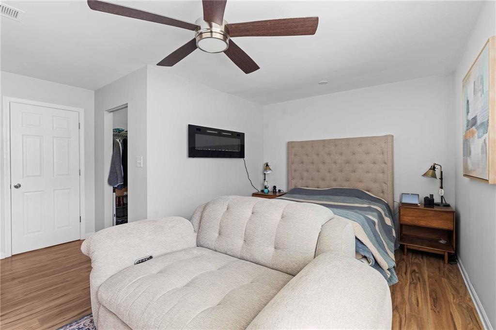 6900 Roswell Road, Unit N5 Atlanta, GA 30328 - Photo 32 of 47 a bedroom with a bed and a chandelier