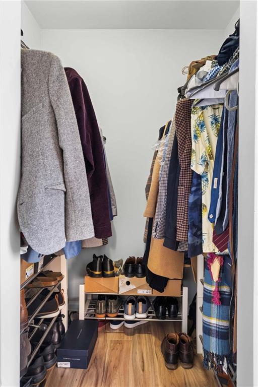 6900 Roswell Road, Unit N5 Atlanta, GA 30328 - Photo 35 of 47 a view of walk in closet with clothes and shoes