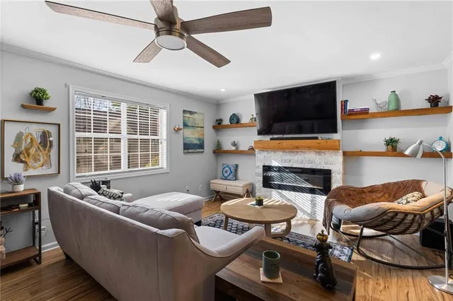 a living room with fireplace furniture and a flat screen tv