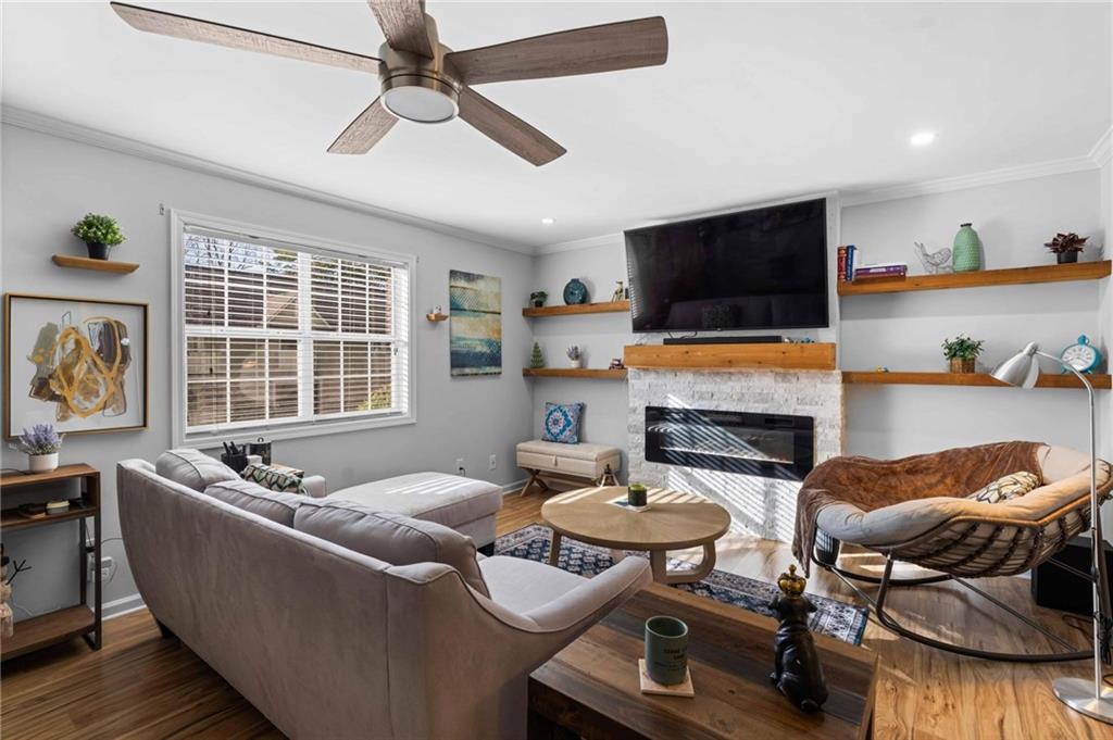 6900 Roswell Road, Unit N5 Atlanta, GA 30328 - Photo 8 of 47 a living room with fireplace furniture and a flat screen tv