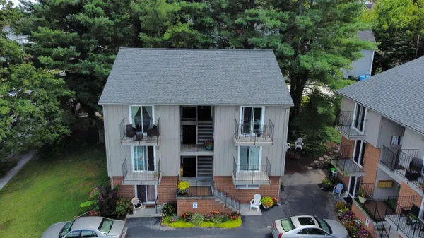 a aerial view of a house with swimming pool lawn chairs and a yard