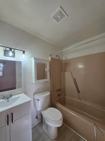 a bathroom with a toilet sink and shower