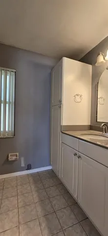 a bathroom with a sink a mirror and a vanity