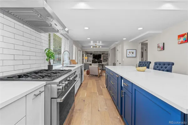 a kitchen with stainless steel appliances granite countertop a stove and a sink