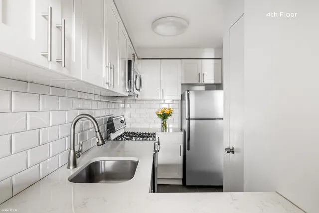 a living room with furniture a fireplace and a window