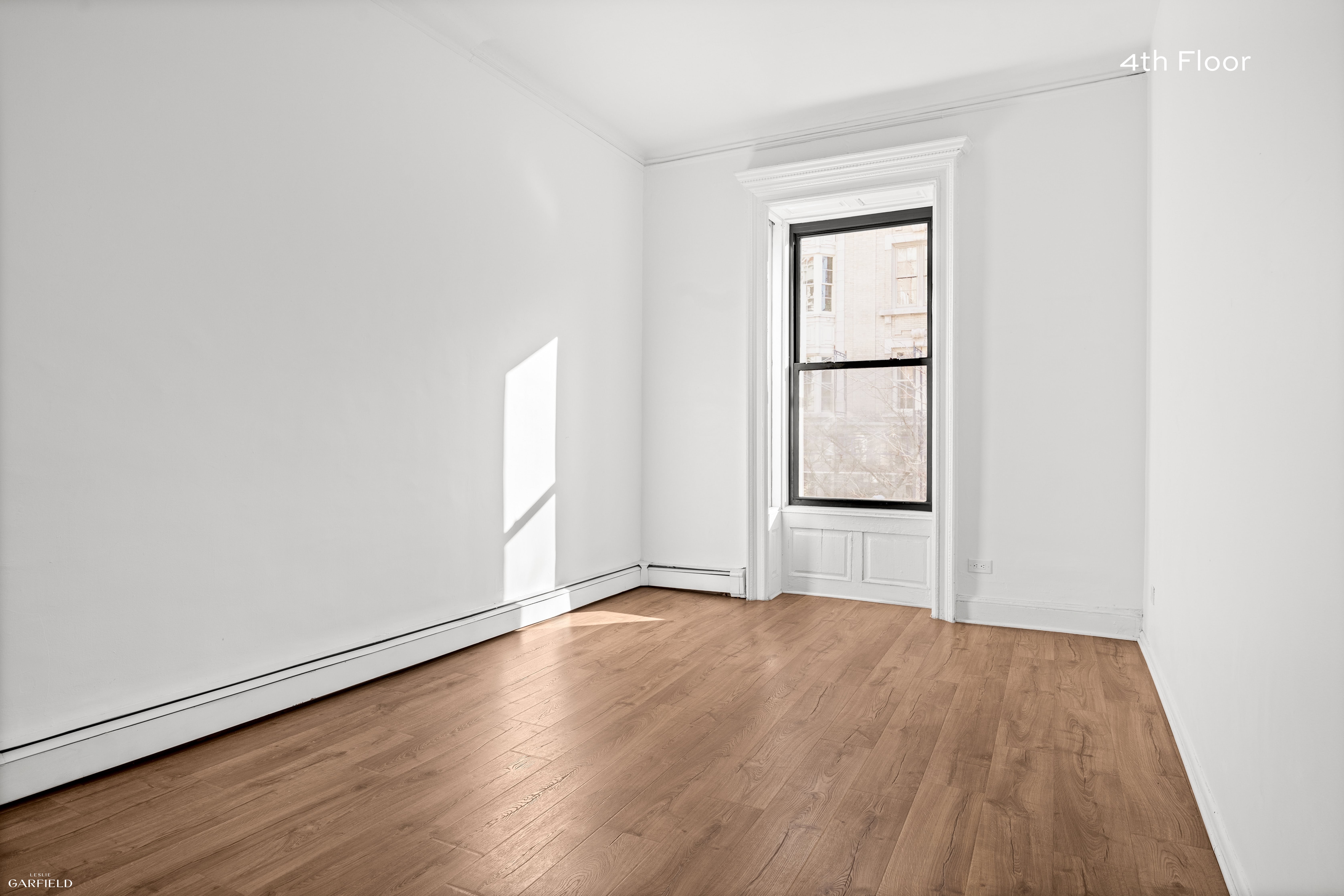 13 West 89th Street Manhattan, NY 10024 - Photo 10 of 17 an empty room with wooden floor and windows