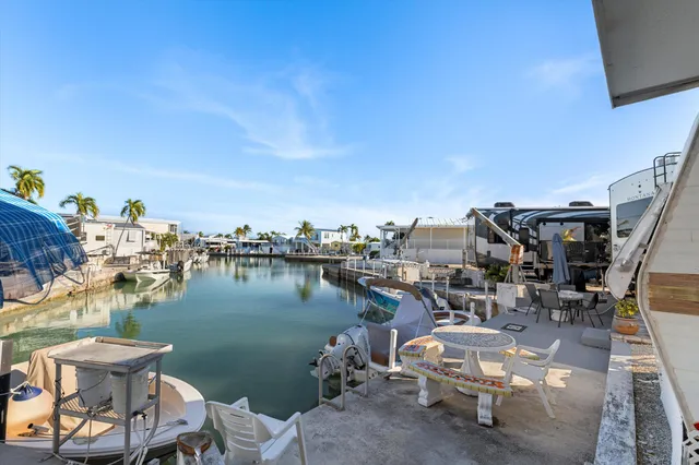 a view of a lake with outdoor seating space